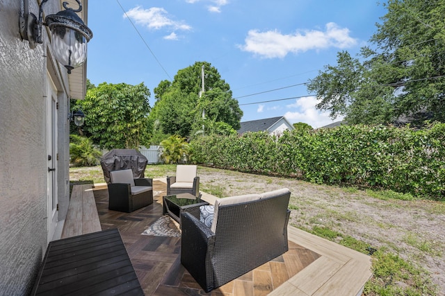 wooden deck featuring an outdoor hangout area and fence