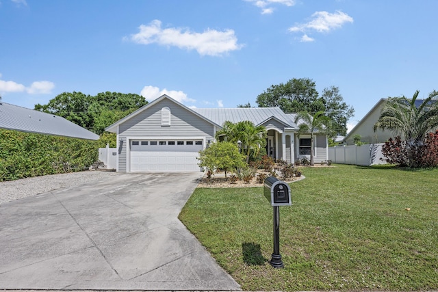 single story home featuring metal roof, a garage, fence, a front lawn, and driveway