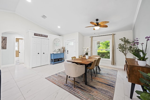 dining space featuring lofted ceiling, baseboards, visible vents, ceiling fan, and arched walkways