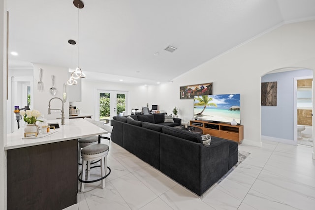 living area with arched walkways, french doors, marble finish floor, and lofted ceiling