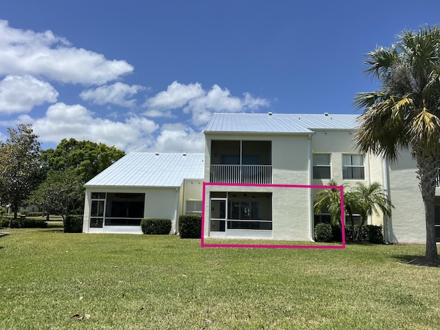 4220 Gator Trace Ave Unit 5E, Fort Pierce, FL 34982 - rear view of property with metal roof, a sunroom, a yard, and stucco siding