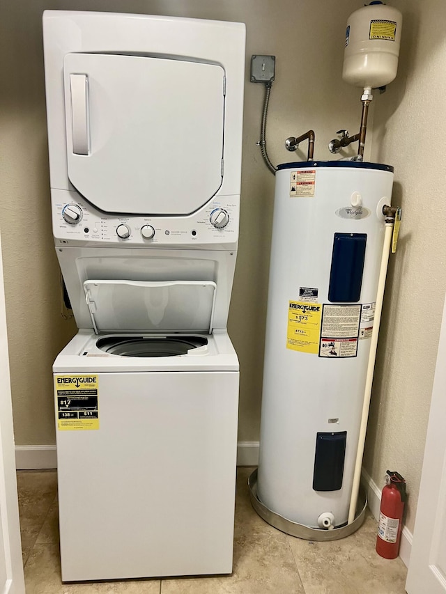 4220 Gator Trace Ave Unit 5E, Fort Pierce, FL 34982 - laundry area featuring water heater, stacked washer / dryer, laundry area, and baseboards