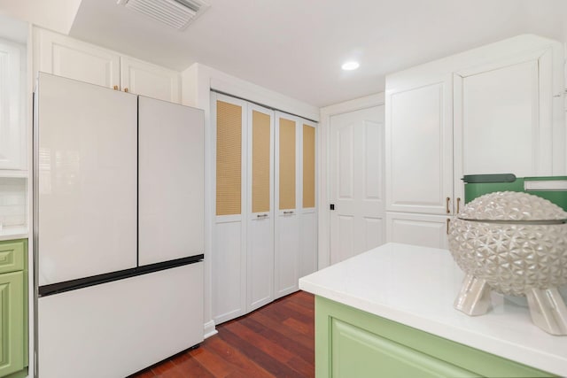 8110 Oakton Ct Unit 10B, Lake Clarke Shores, FL 33406 - kitchen featuring green cabinets, dark wood-style flooring, light countertops, recessed lighting, and white cabinetry