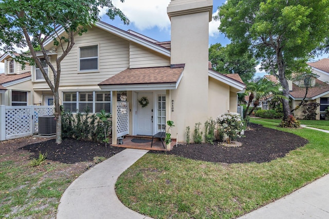 8110 Oakton Ct Unit 10B, Lake Clarke Shores, FL 33406 - view of front of property featuring central air condition unit, roof with shingles, a chimney, and stucco siding