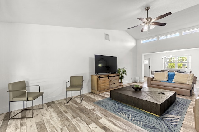 944 Hansen St, West Palm Beach, FL 33405 - living area with a chandelier, wood finished floors, ceiling fan, high vaulted ceiling, and baseboards