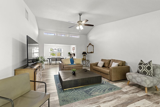 944 Hansen St, West Palm Beach, FL 33405 - living room featuring ceiling fan, a chandelier, light wood-style flooring, and high vaulted ceiling