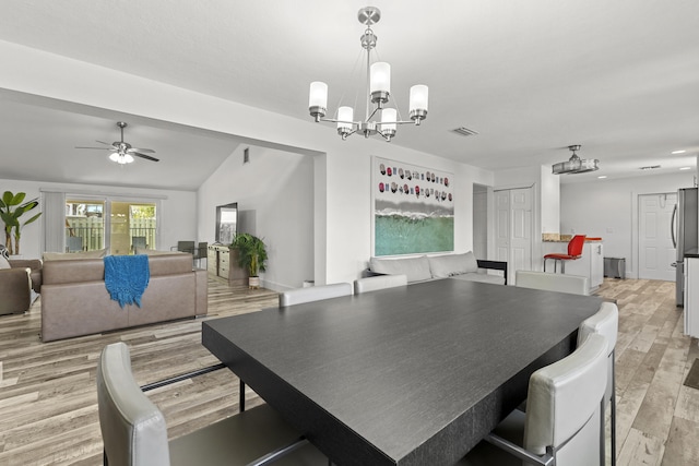 944 Hansen St, West Palm Beach, FL 33405 - dining room with a chandelier, light wood-type flooring, ceiling fan, and vaulted ceiling