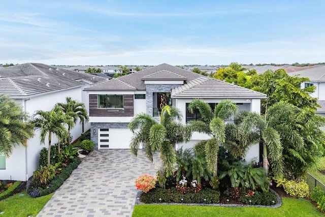 17045 Five Waters Ave, Boca Raton, FL 33496 - view of front of home with a garage, driveway, stucco siding, and a tiled roof