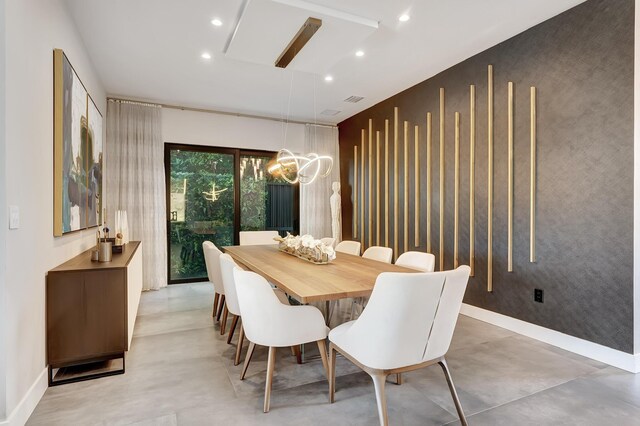 17045 Five Waters Ave, Boca Raton, FL 33496 - dining room with concrete floors, baseboards, and a notable chandelier