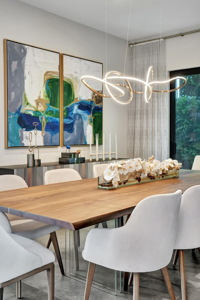 17045 Five Waters Ave, Boca Raton, FL 33496 - dining area with finished concrete flooring and an inviting chandelier