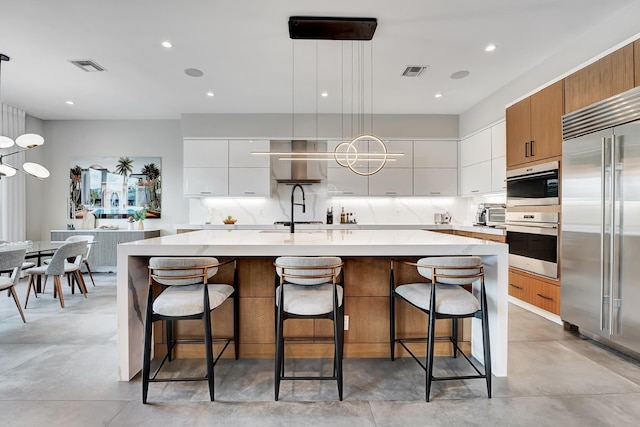 17045 Five Waters Ave, Boca Raton, FL 33496 - kitchen featuring stainless steel appliances, visible vents, modern cabinets, and light countertops