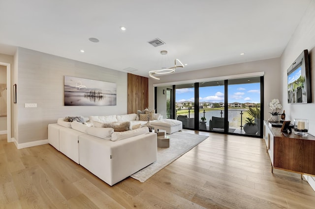 17045 Five Waters Ave, Boca Raton, FL 33496 - living room featuring recessed lighting, light wood finished floors, visible vents, and an inviting chandelier