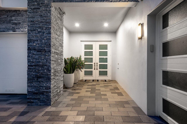 17045 Five Waters Ave, Boca Raton, FL 33496 - property entrance with french doors, stone siding, and stucco siding
