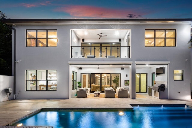 17045 Five Waters Ave, Boca Raton, FL 33496 - back of house with a patio, an outdoor pool, a balcony, and stucco siding