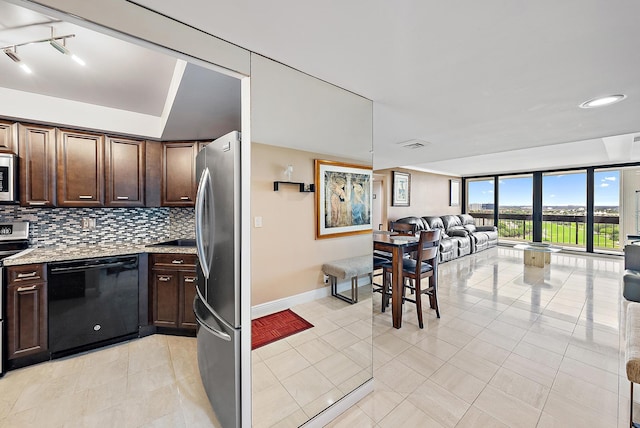 2400 Presidential Way Unit 1204, West Palm Beach, FL 33401 - kitchen with appliances with stainless steel finishes, dark brown cabinets, open floor plan, decorative backsplash, and baseboards