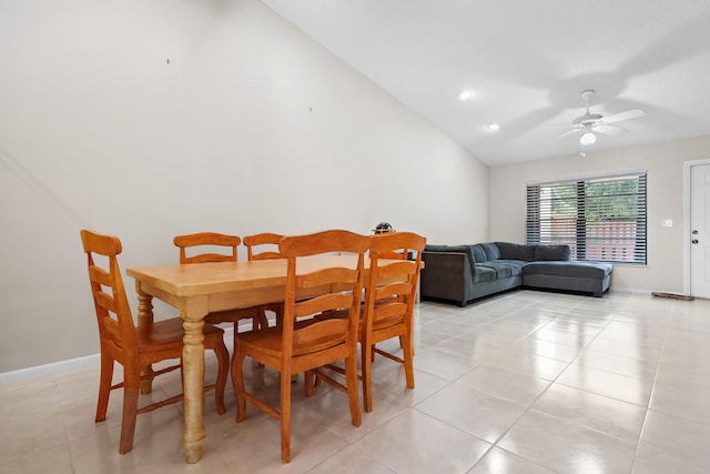dining room featuring vaulted ceiling, baseboards, a ceiling fan, and light tile patterned flooring