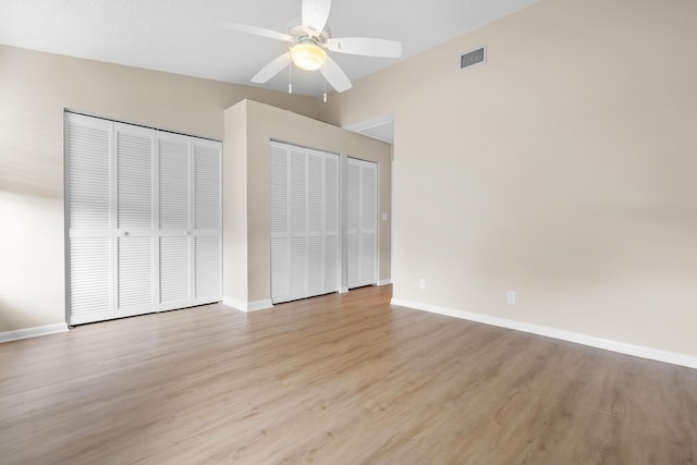 unfurnished bedroom featuring light wood-type flooring, baseboards, a ceiling fan, and visible vents