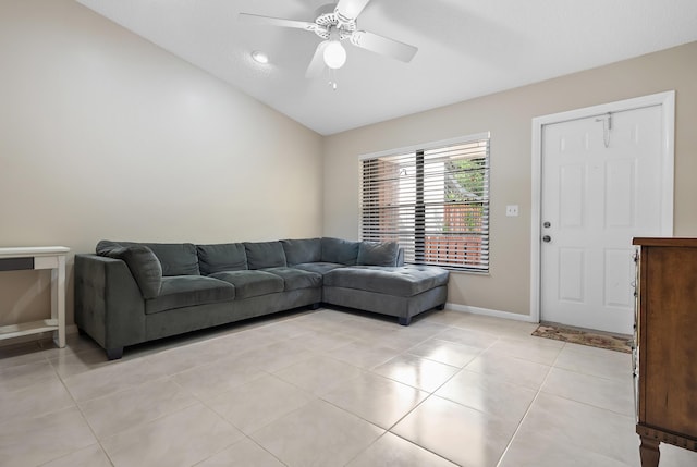 living room featuring ceiling fan, light tile patterned flooring, baseboards, and lofted ceiling