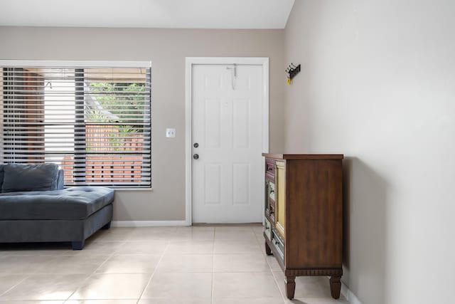 foyer entrance featuring baseboards and light tile patterned flooring