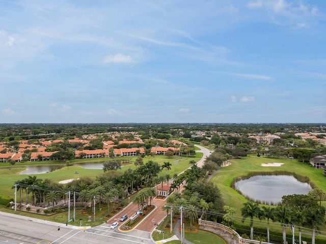 drone / aerial view with golf course view, a residential view, and a water view
