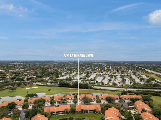 aerial view featuring a water view, golf course view, and a residential view