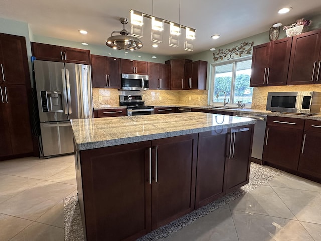 kitchen featuring light tile patterned floors, a sink, backsplash, appliances with stainless steel finishes, and recessed lighting