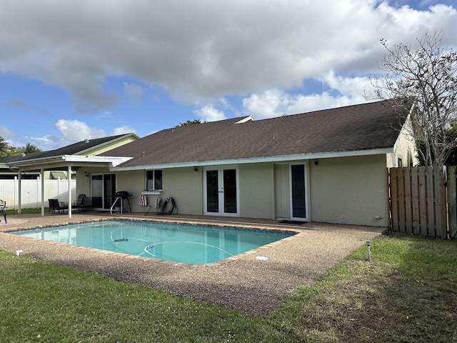 view of pool featuring fence, a patio, a fenced in pool, and french doors