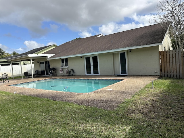 view of swimming pool with fence, french doors, a patio area, and a fenced in pool