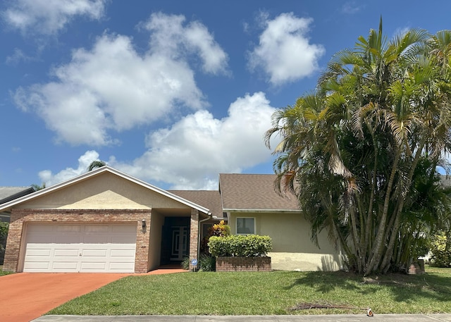 ranch-style home with driveway, brick siding, an attached garage, stucco siding, and a front lawn