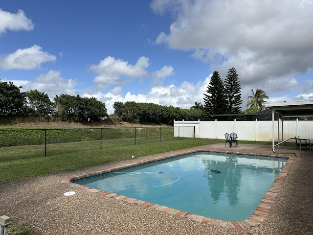 view of swimming pool featuring fence, a fenced in pool, and a lawn