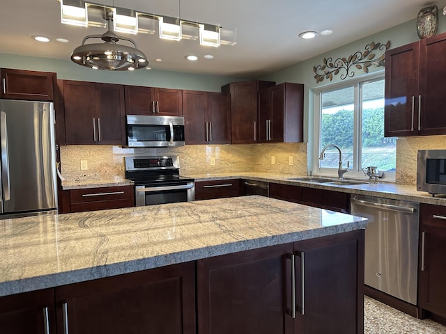 kitchen with stainless steel appliances, tasteful backsplash, and a sink