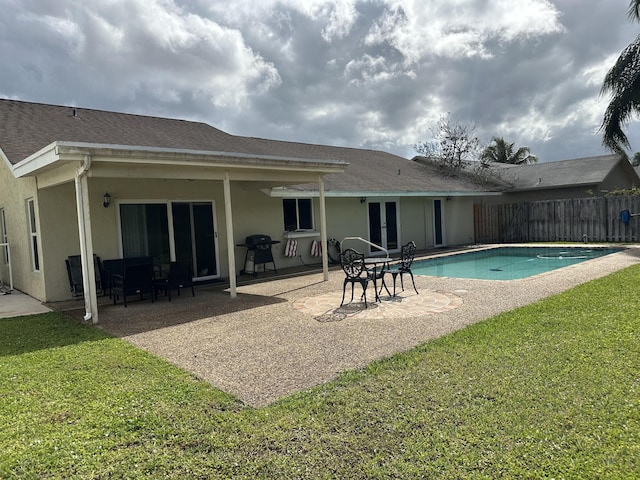 view of pool featuring a yard, fence, a patio, and a fenced in pool