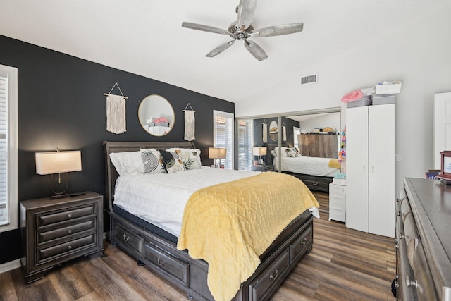 bedroom featuring visible vents, a ceiling fan, dark wood finished floors, and lofted ceiling