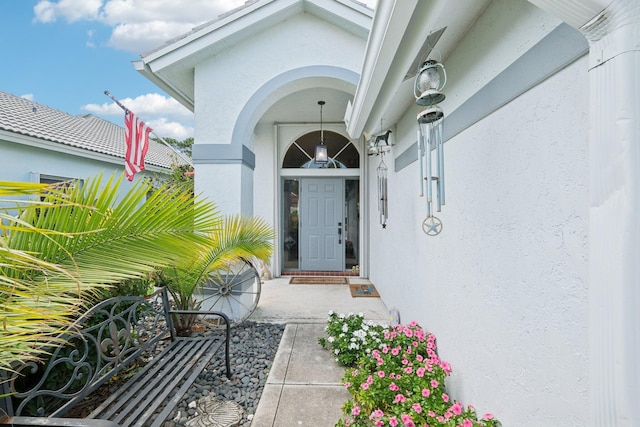 property entrance with stucco siding