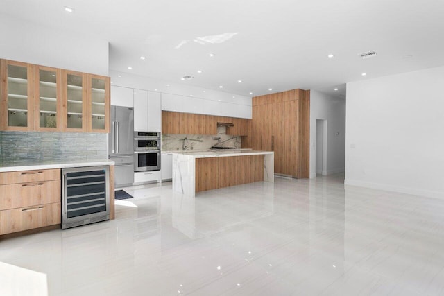 306 Plymouth Rd, West Palm Beach, FL 33405 - kitchen with stainless steel appliances, modern cabinets, backsplash, and wine cooler