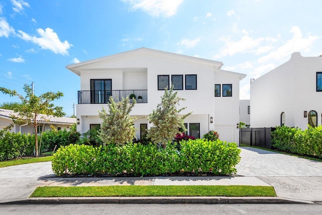 306 Plymouth Rd, West Palm Beach, FL 33405 - view of front facade featuring a garage, a balcony, decorative driveway, and stucco siding