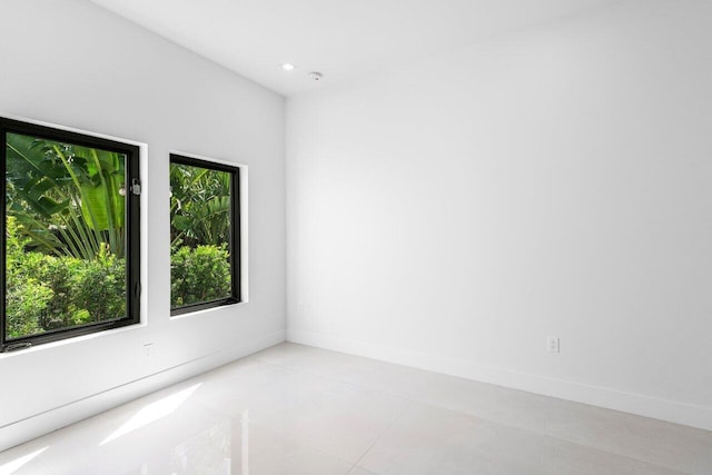 306 Plymouth Rd, West Palm Beach, FL 33405 - unfurnished room featuring light tile patterned floors, baseboards, and recessed lighting