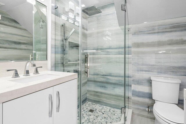 306 Plymouth Rd, West Palm Beach, FL 33405 - bathroom featuring toilet, a shower stall, and vanity