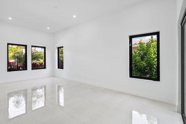 306 Plymouth Rd, West Palm Beach, FL 33405 - spare room with recessed lighting, light tile patterned floors, and a healthy amount of sunlight