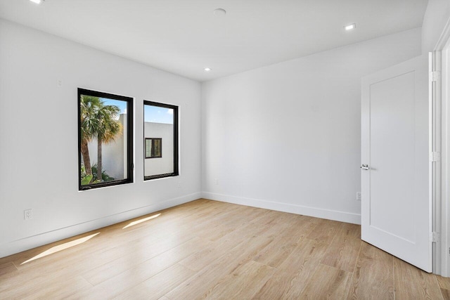 306 Plymouth Rd, West Palm Beach, FL 33405 - unfurnished room featuring baseboards, light wood-type flooring, and recessed lighting