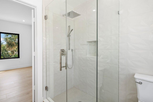 306 Plymouth Rd, West Palm Beach, FL 33405 - bathroom with a shower stall, baseboards, toilet, and wood finished floors