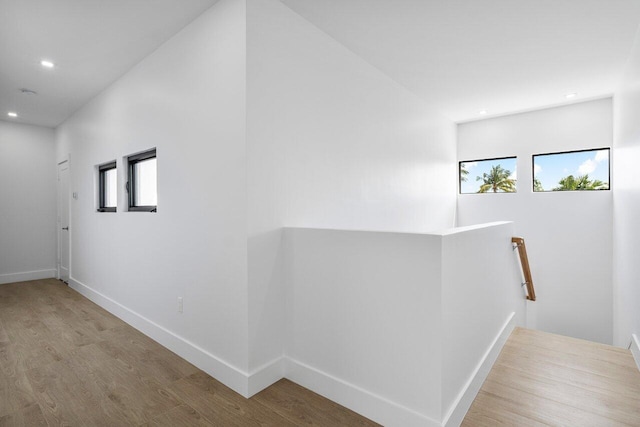 306 Plymouth Rd, West Palm Beach, FL 33405 - corridor featuring wood finished floors, recessed lighting, an upstairs landing, and a wealth of natural light