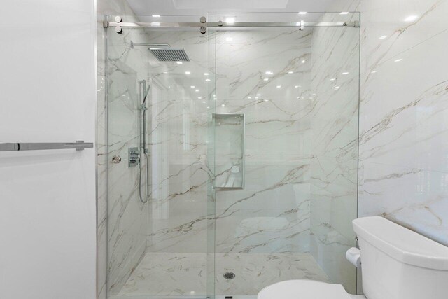 306 Plymouth Rd, West Palm Beach, FL 33405 - full bathroom with a marble finish shower and toilet
