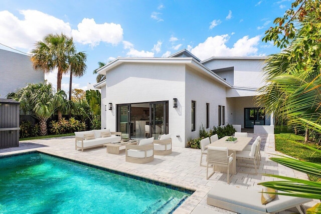 306 Plymouth Rd, West Palm Beach, FL 33405 - rear view of property featuring an outdoor hangout area, stucco siding, a patio, an outdoor pool, and outdoor dining space