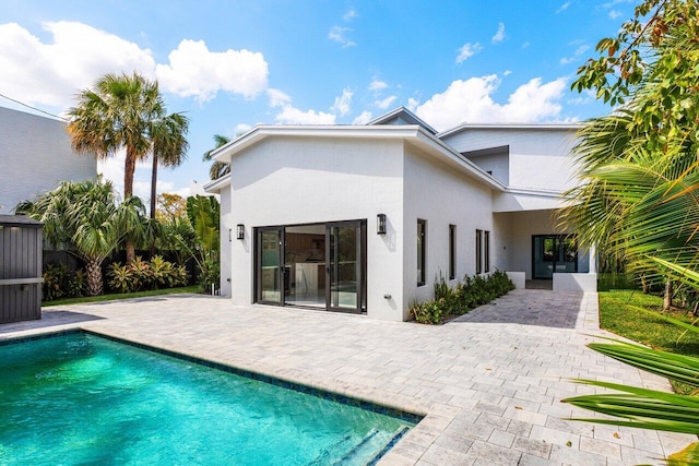 306 Plymouth Rd, West Palm Beach, FL 33405 - back of house featuring a patio area, an outdoor pool, and stucco siding