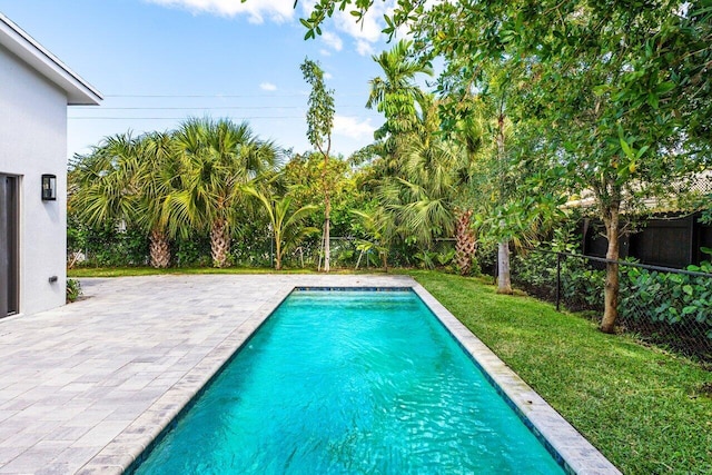 306 Plymouth Rd, West Palm Beach, FL 33405 - outdoor pool featuring a yard, a patio area, and a fenced backyard