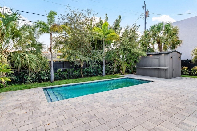 306 Plymouth Rd, West Palm Beach, FL 33405 - view of swimming pool with a storage shed, a fenced backyard, a patio, an outbuilding, and a fenced in pool