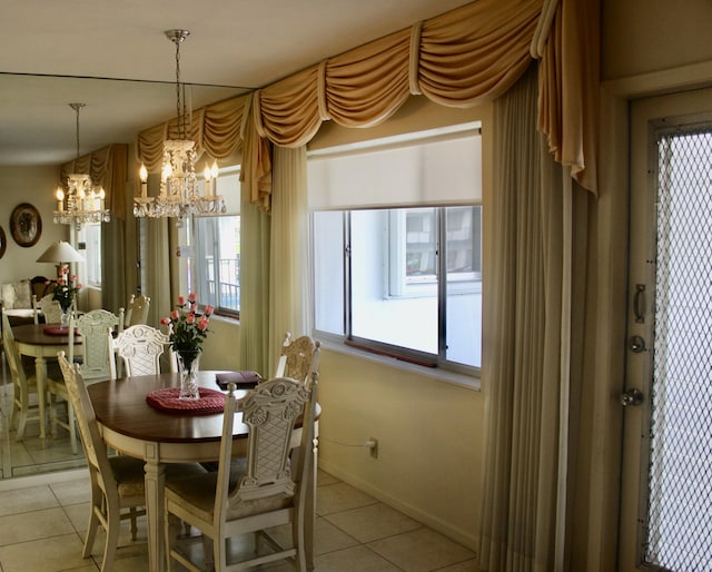 dining area featuring light tile patterned floors and an inviting chandelier