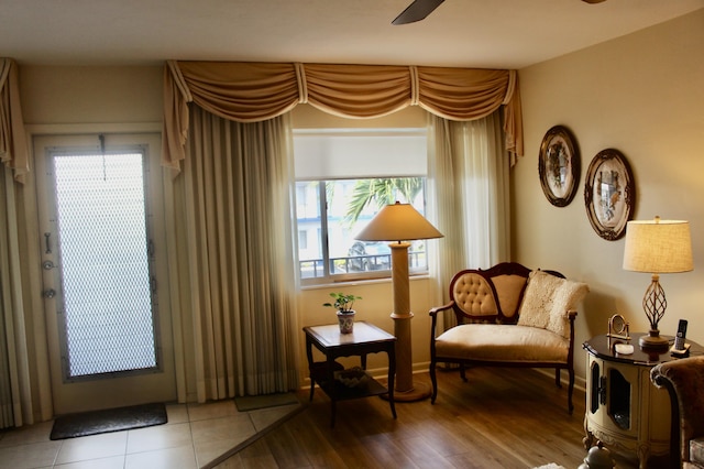 living area featuring wood finished floors and ceiling fan