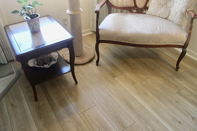 interior space with wood finished floors and baseboards